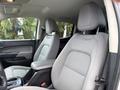 Interior view of the front seats in a 2018 Chevrolet Colorado featuring gray fabric upholstery and a console between the seats