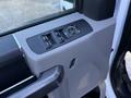 Interior door panel of a 2020 Ford F-350 featuring window controls and a power mirror adjustment knob