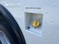 Fuel access point on a 2012 Ford E-450 with a yellow cap labeled unleaded fuel only