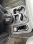 A top-down view of the interior console of a 2006 Dodge Ram 2500 featuring a gear shift and multiple cup holders