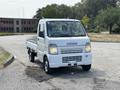 White 2008 Suzuki Carry pickup truck with a flatbed and a compact design parked on a paved surface