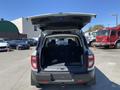A 2023 Ford Bronco Sport with its rear hatch open displaying a spacious cargo area and rear seats folded down