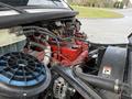 Close-up of the engine compartment of a 2015 Freightliner M2 showing visible components like belts hoses and a red valve cover