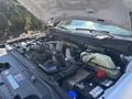Engine compartment of a 2023 Ford F-350 SD showcasing various components including the engine block and fluid reservoirs