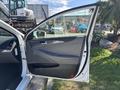 A 2015 Hyundai Sonata with the driver's side door open displaying the interior controls and door panel details