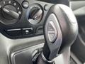 Close-up of the gear shift lever in a 2017 Ford Transit Connect featuring buttons for various functions on the shifter