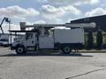 A 2019 Freightliner M2 106 bucket truck equipped with an elevated platform and storage compartments on the side