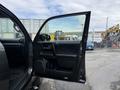 A 2021 Toyota 4Runner with the driver's side door open displaying the interior features including the door panel and seat