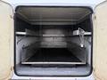 The interior of a 2015 Ford F-450 cargo area with metal shelves on both sides and a flat floor space for storage
