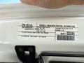 A 2021 Jeep Wrangler with a visible vehicle emission control information label showing specifications and compliance details