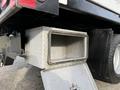 A metal diamond plate storage box attached to the rear of a 2015 Ford F-350 with a lid open and no contents visible inside