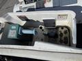 A 2008 International 7500 dashboard showing various controls, gauges, and warning labels with a green component and a blue handle visible