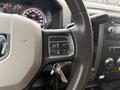 Steering wheel of a 2012 Dodge Ram 4500 with control buttons for cruise control and keychain keys hanging from the ignition