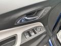 Interior door panel of a 2022 Chevrolet Equinox featuring control buttons for windows and door locks along with a stylish handle design