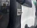 A close-up view of a metal connector on a 2021 Ford Transit-350 with water droplets on the surface