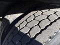 Close-up of the tread on a rubber tire of a 2012 Freightliner M2 106 showing deep grooves and patterns for traction