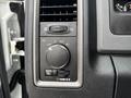 Control panel of a 2013 RAM 1500 featuring dials for headlights and air conditioning with various settings and indicators