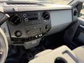Interior dashboard of a 2015 Ford F-550 featuring a radio control panel and air conditioning vents