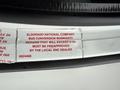 2013 Chevrolet Express with a warranty notice for bus conversion repairs displayed on the interior dashboard