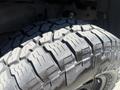 Close-up of a tire from a 2010 Toyota Tacoma showing detailed tread patterns designed for traction and grip