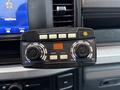 A control panel from a 2023 Ford F-250 featuring knobs for material width and flow along with buttons for on/off and blast settings