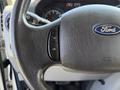 Steering wheel of a 2015 Ford Econoline showing the Ford logo and control buttons with an on and off switch