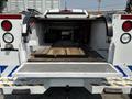 A 2017 Chevrolet Colorado with an open tailgate showing a metal-lined cargo bed and wooden planks inside