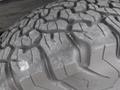 Close-up of a tire tread from a 2015 Chevrolet Silverado 1500 showcasing deep grooves and rugged texture