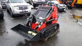 A red and black 2023 AGT Industrial compact track loader with a front bucket attachment positioned on a wooden pallet