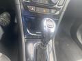 Interior console of a 2018 Buick Encore featuring a gear shift lever with chrome detailing and buttons for drive modes