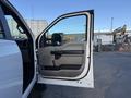 A 2020 Ford F-550 truck with its driver's side door open showing the interior door panel and handle