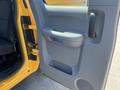 The image shows the interior driver's side door of a 2013 Chevrolet Silverado 1500 featuring a handle and speaker with a yellow exterior visible around the door frame