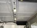 Interior view of a 2017 Ford Transit showcasing the ceiling with lighting fixtures and a partition in the rear area