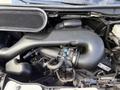 Close-up of the engine compartment of a 2016 Ford Transit showcasing the air intake system and various components including hoses and a throttle body