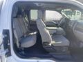 Interior view of a 2017 Ford F-150 showing front seats with gray upholstery and a console between them