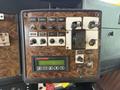Dashboard controls of a 1996 Kenworth T800 featuring various switches knobs and a digital display for vehicle settings and operations