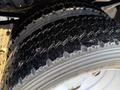 Close-up of the tread on two heavy-duty tires from a 2010 Ford F-550 showing deep grooves designed for traction and grip