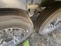 Close-up of two tires from a 2021 Grand Design Recreational ST3478MBS showing detailed tread patterns and metallic rims