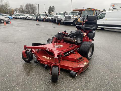 A red 2017 Ferris Rotary lawn mower with a large cutting deck and a rider seat is parked on a gravel surface