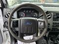 Interior view of a 2012 Ford F-550 with a steering wheel featuring the Ford logo and various controls visible