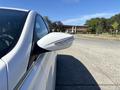 A 2015 Hyundai Sonata with a sleek white exterior and a side mirror featuring integrated turn signal lights