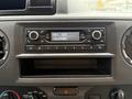 Dashboard of a 2022 Ford E-450 featuring a radio display with time and frequency settings and various control knobs