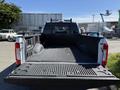 A 2017 Ford F-350 SD pickup truck with an empty bed and a textured rubber mat inside