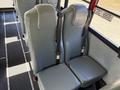Interior seats of a 2013 International CE300 school bus featuring two gray padded seats with seat belts