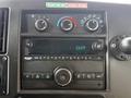 Dashboard controls of a 2019 Chevrolet Express featuring air conditioning knobs a radio display and various audio controls