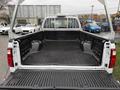 The image shows the open bed of a 2008 Ford F-250 SD featuring a black plastic liner and a white truck body