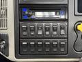 Dashboard control panel of a 2013 International Workstar 7500 featuring a radio and various switches for different vehicle functions