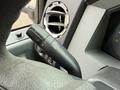 A 2012 Ford F-550 steering column with a multifunction lever for headlights and windshield wipers