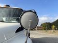 A 2012 International DuraStar 4300 showing the side mirror prominently in focus with a round reflective surface