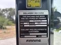 A delivery record sticker on a 2012 Caterpillar 980 indicating it has been pre-delivered by Finning with details such as warehouse location model and serial number